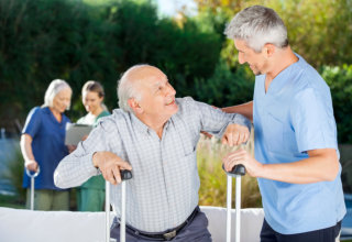 caregiver assisting old man